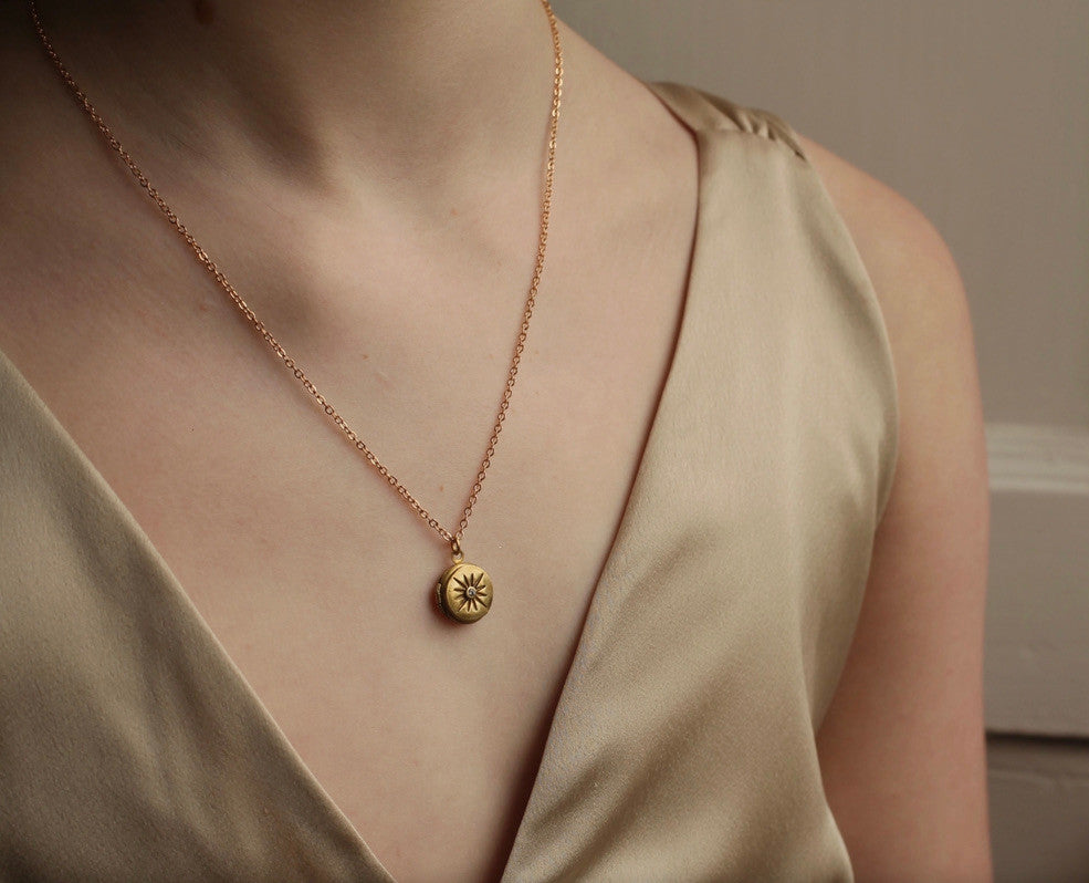 TINY COMPASS STAR LOCKET